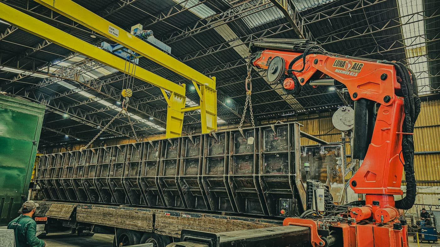 Crane loading steel inventory inside a distribution warehouse
