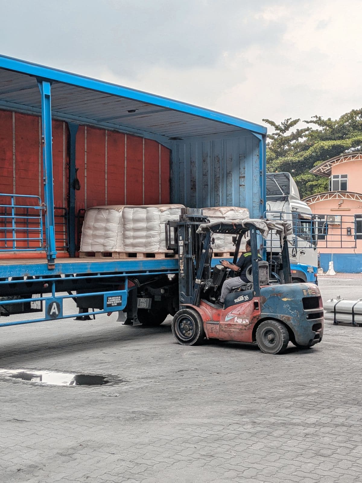 Forklift loading material onto a delivery truck
